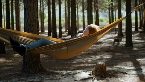 woman sleeping on a hammock in the forest 4k