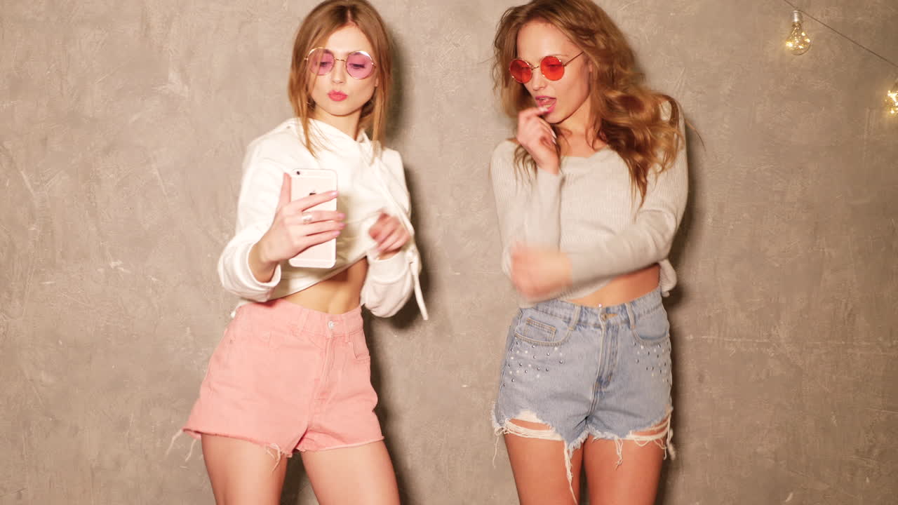 두 친구가 셀카를 찍고 있습니다.