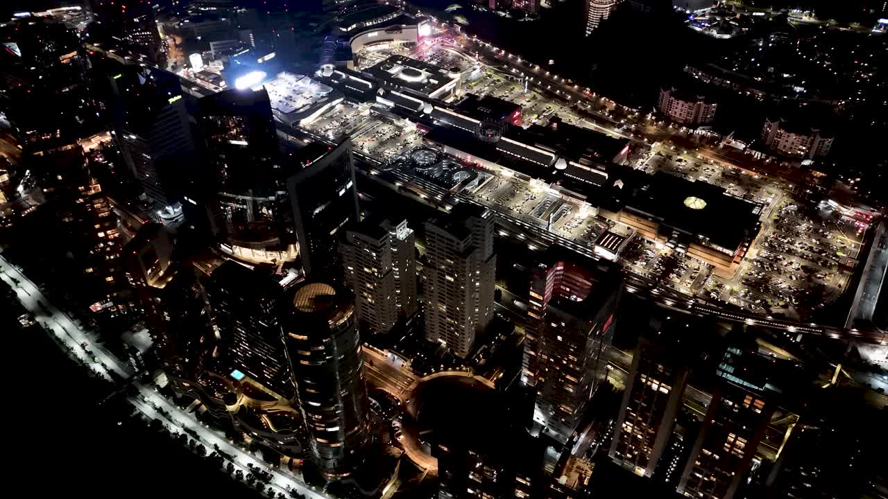 Santa Fe lights up the night, drone view of Mexico City