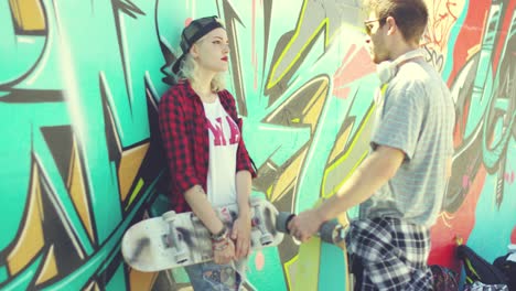 couple of young skateboards standing chatting