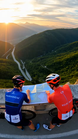 cyclists planning their route on a mountain pass during golden hour