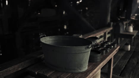 vintage metal bucket and cups on rustic wooden table