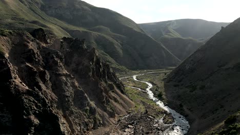 aerial view of the campanario river with the homonymous hot springs with the sunlight at dawn in the maule region, chile