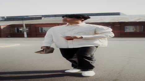 man walking in city street with drink and food