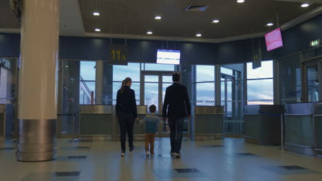 parents and son in airport terminal