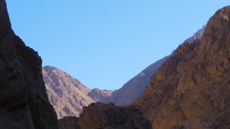 view with rocky mountains at colored canyon of egypt sinai desert dahab in sunny day, wide shot with zoom in