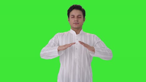 indian man doing breathe in breathe out exercise green screen