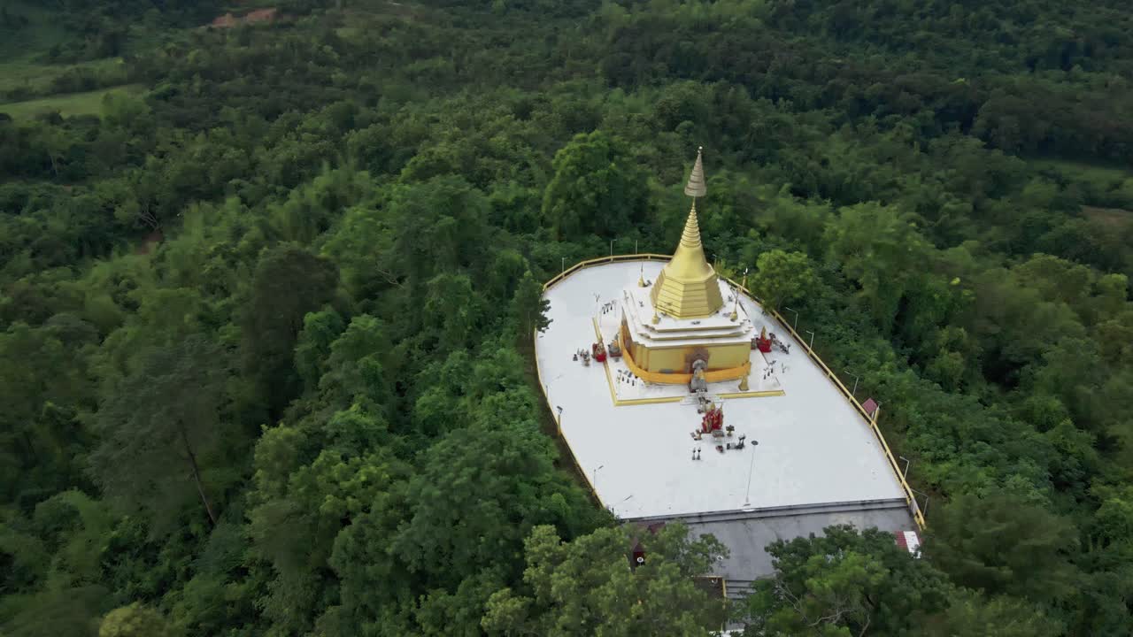 estupa dorada en la cima de una colina con árboles verdes del bosque en la provincia de saraburi, tailandia