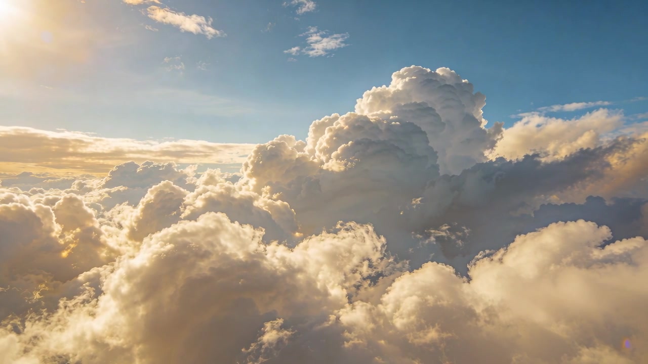 Sliding camera moving forward right over clouds at sunset, sun left, towering cloud casting shadows
