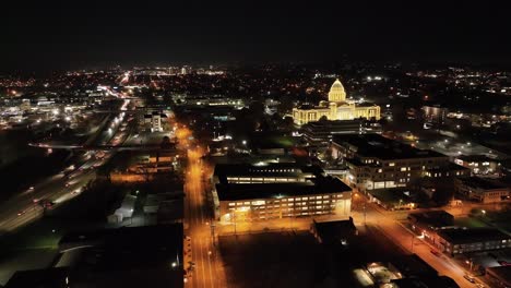 arkansas state capitol building at night in little rock, arkansas with drone video moving down wide shot