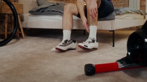 man getting ready for a cycling workout at home