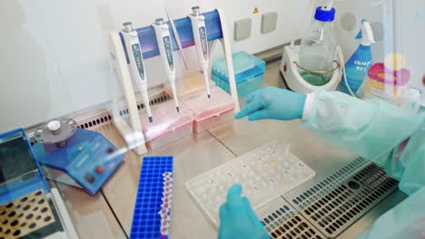 medical equipment on the table in laboratory. female hands working with test tubes. researcher in his work place in modern lab.