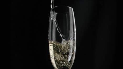 Animation-of-red-shapes-spinning-over-glass-of-champagne-on-black-background