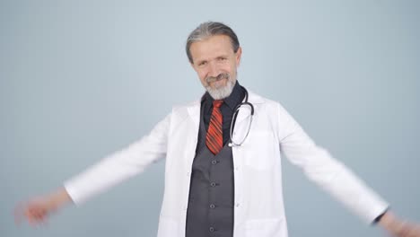 doctor making heart looking at camera.