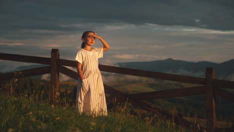 girl in a dress at sunset in the mountains