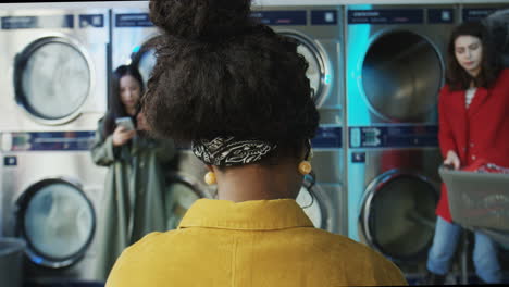 rear of stylish woman in laundry service room