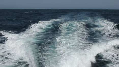 wake of water seen from behind of fast moving motor boat in a clear sky day,blue sea , water surface.destination vacation travel tropical ocean sea.beautiful background .