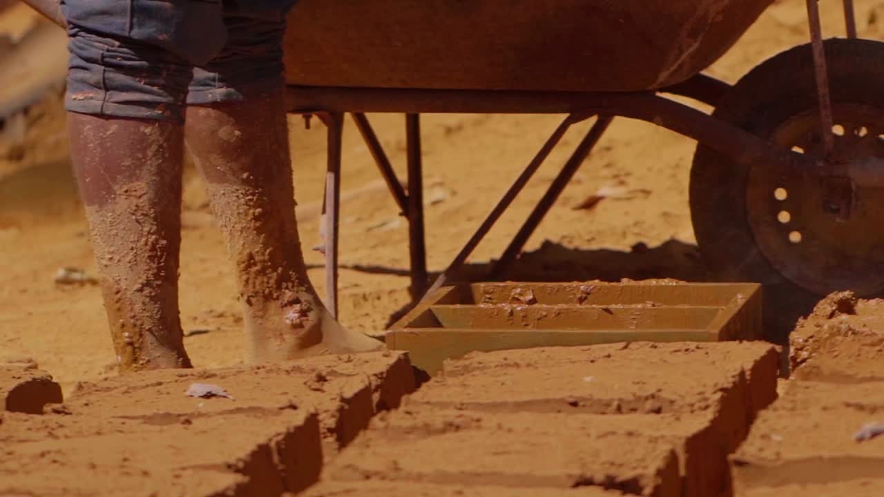 Construction worker making adobe bricks using traditional methods in Chapada dos Veadeiros, promoting sustainable building practices and cultural preservation