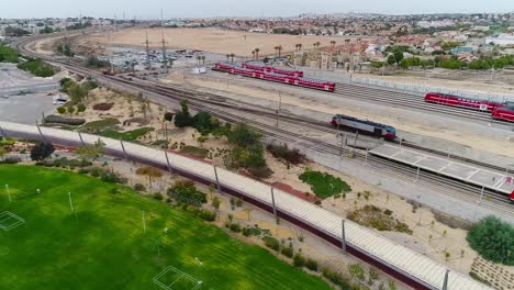 aerial drone shot over a railway area and recreation spaces. on a sunny day.