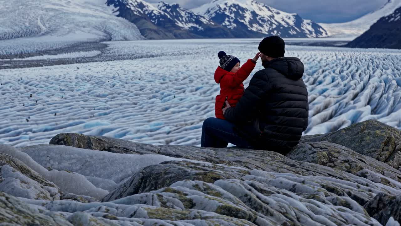 Father and son enjoying a glacier view