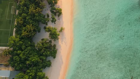 a breathtaking aerial drone view captures rasdhoo island bathed in the warm glow of sunset in the maldives.