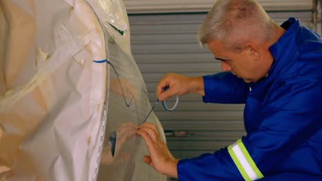 engineer marking a line on airplane parts 4k