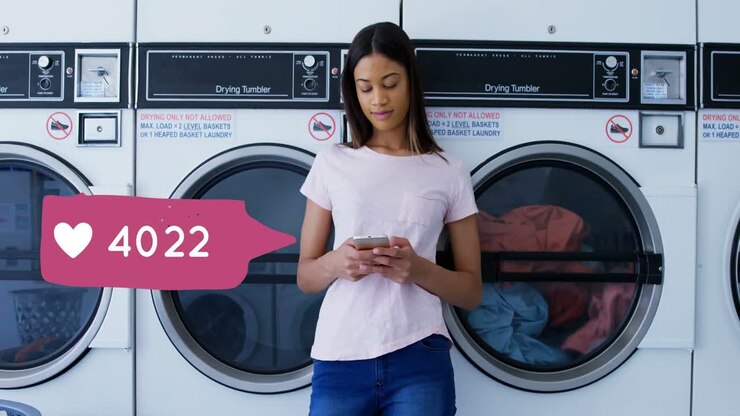 Woman typing on her phone while waiting for laundry 4k