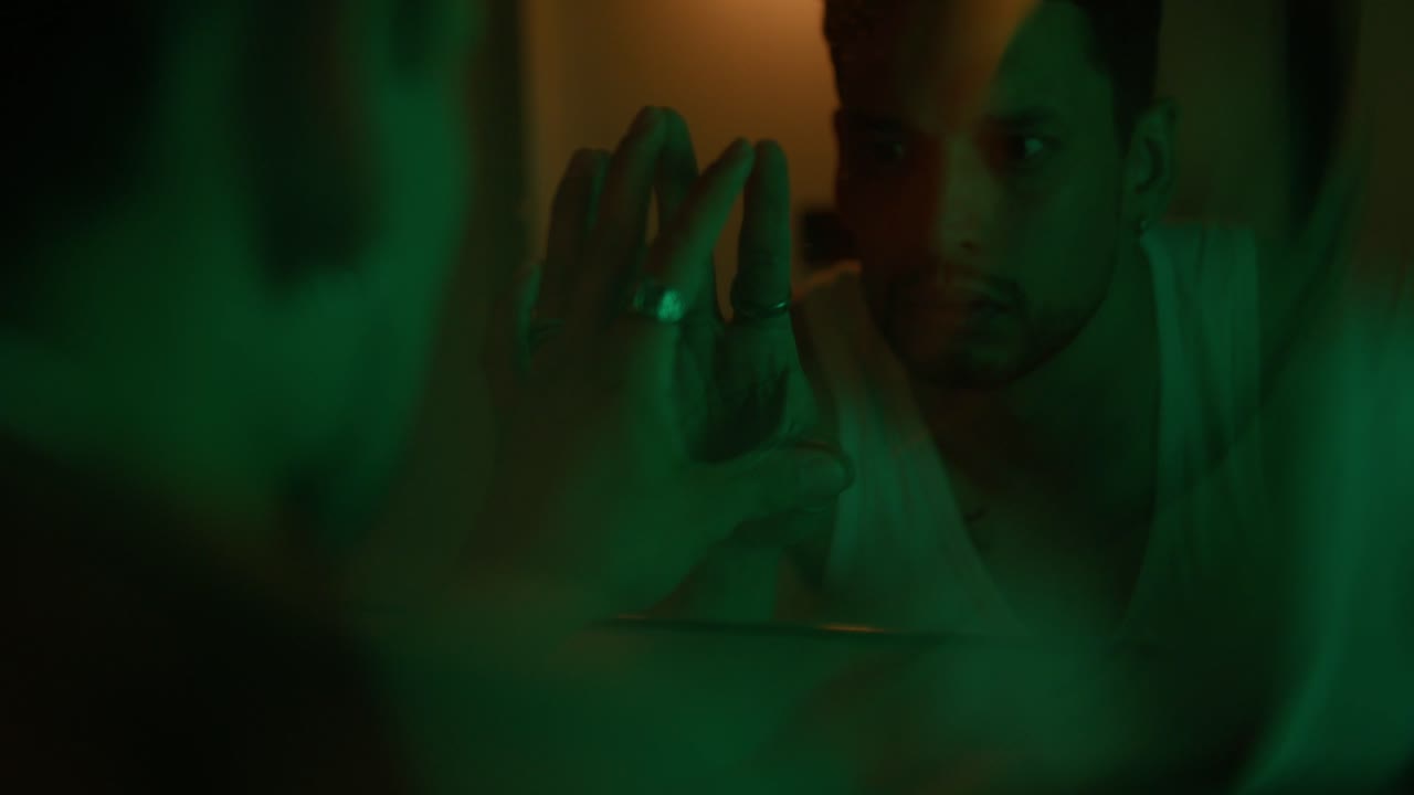 Man looking in mirror with green light