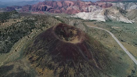 slowly flying over a perfectly shaped volcano with a huge crater opening in utah