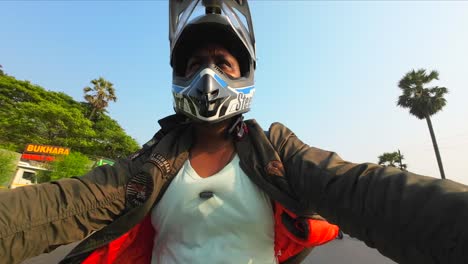 indian bike rider with jacket riding motorcycle on indian road sports helmet