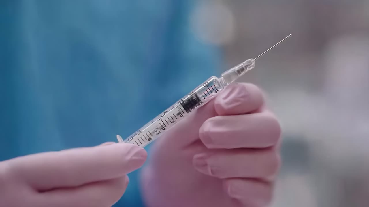 A Close-Up Look at a Medical Professional Holding a Syringe in a Clinical Setting, Highlighting the Importance of Vaccination and Medical Procedures
