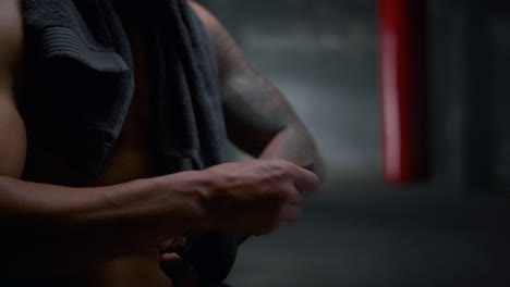 man pulling bandages on hands. guy wrapping hands with punching wraps
