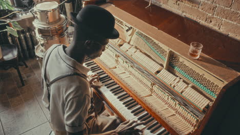 man playing piano in a jazz bar