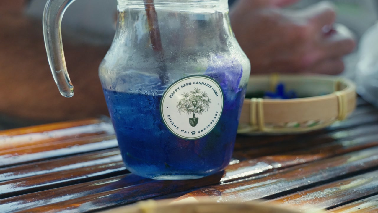 A Thai herbal tea served on a table, showcasing traditional ingredients and a warm, natural atmosphere.
