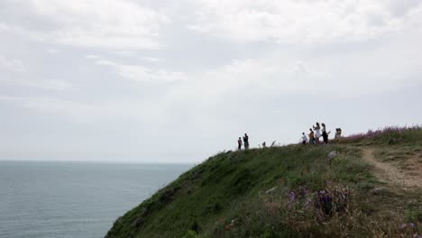 several tourists on the mountain in cape kaliakra nature reserve, black sea coast, bulgaria. wide shot
