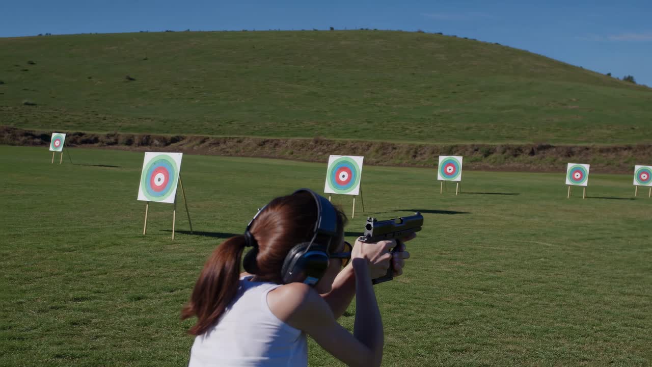 Woman Shooting at Targets at a Shooting Range