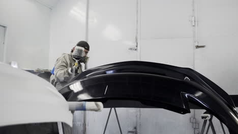 car bumper painting in a body shop