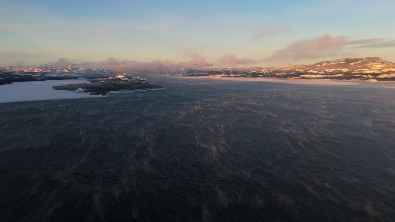 Frozen Lake Laberge During Sunset In Yukon, Canada - Drone Shot
