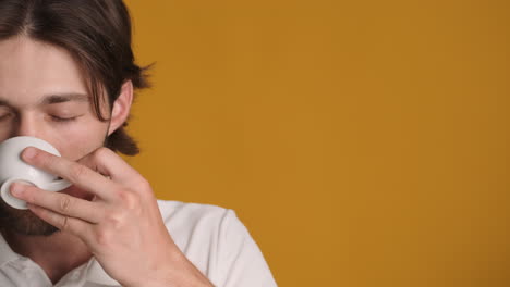 caucasian man in front of camera on yellow background.