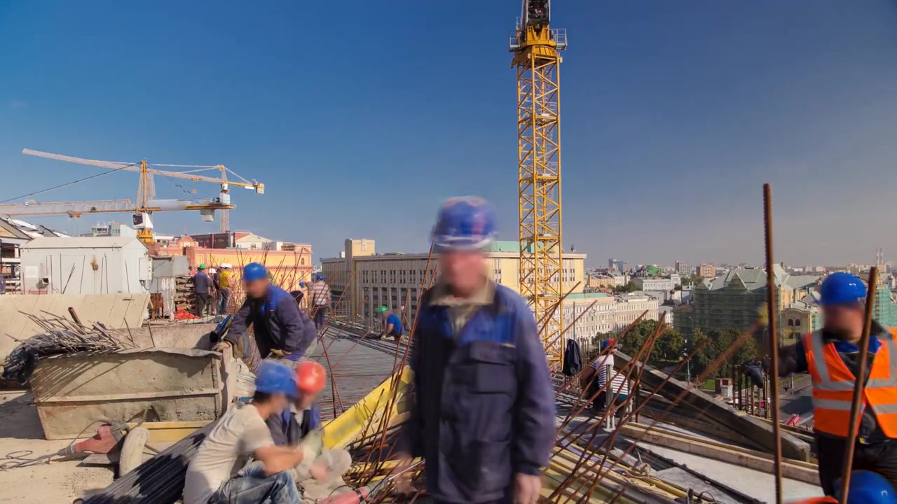 Steel bar rebar metal framework reinforcement for concrete at construction site with cranes timelapse. Metal works on a roof of new building in progress with many workers in uniform