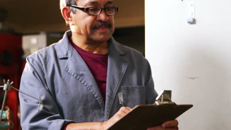 shoemaker writing on clipboard