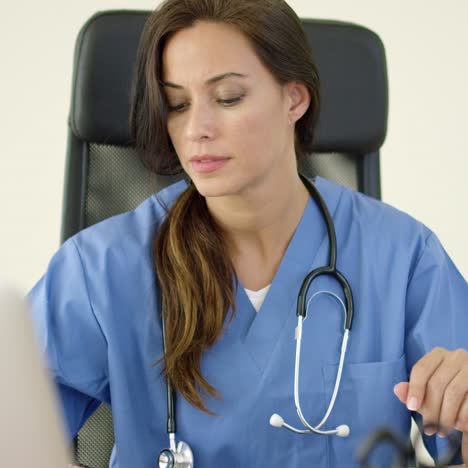 Serious-female-doctor-at-laptop-computer