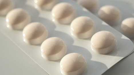 close-up of blister packs of round white pills