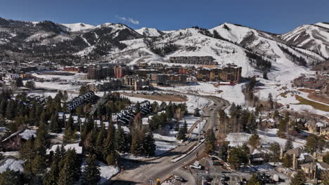 park city utah aerial v65 flyover canyons village resort surrounded by wild nature, capturing beautiful scenic mountainscape covered in snow on a sunny day - shot with mavic 3 cine - february 2022