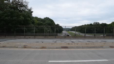 Cars-driving-by-on-a-bridge