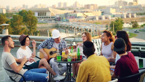 friends having a rooftop party with music