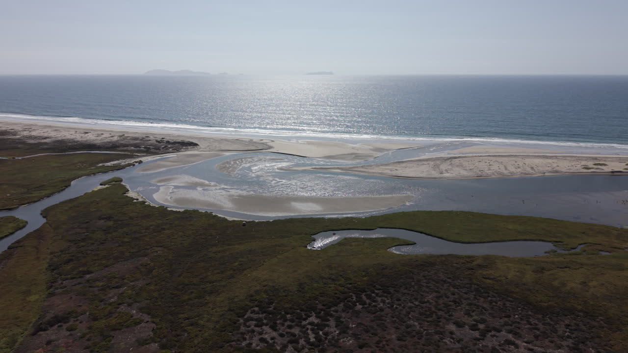 Drone view of the Tijuana River flowing into the Pacific at Imperial Beach, California—showing polluted waters and environmental health hazards