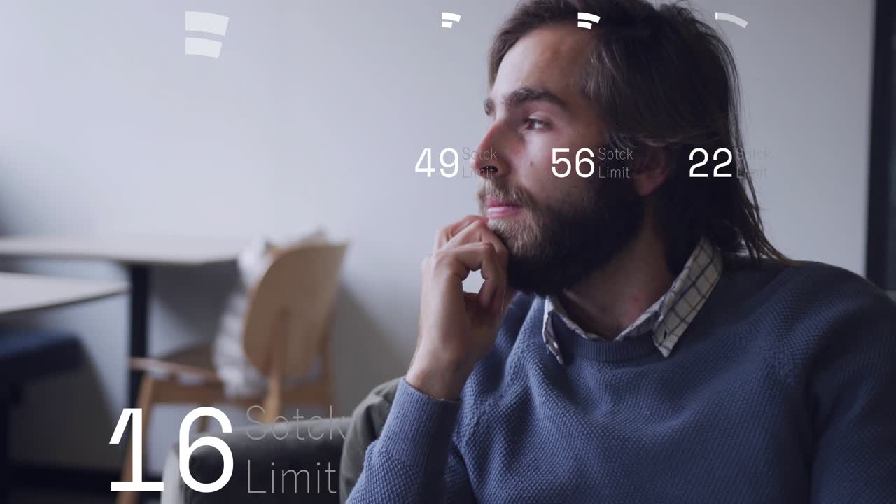 Man sitting on couch watching HUD graphics appearing and analyzing circular meter for tech demo