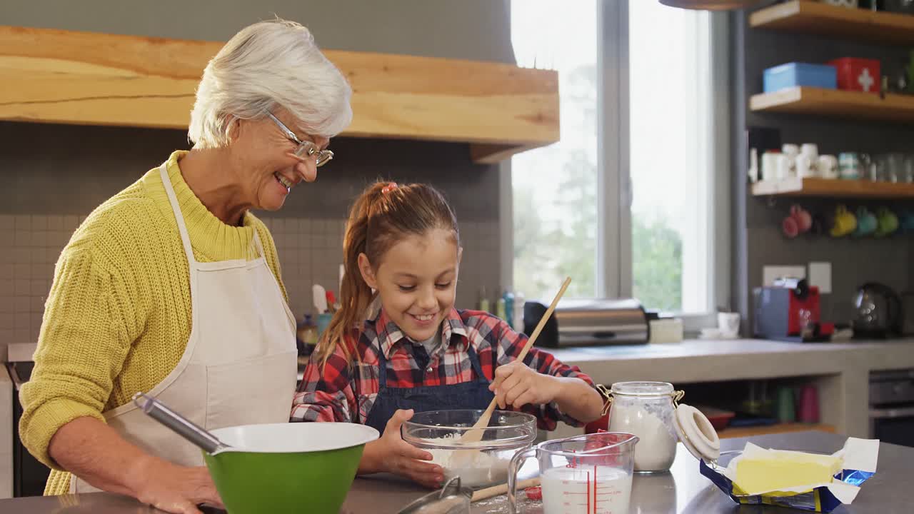 Grandmother watching the girl happily while mixing flour 4K 4k