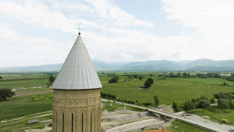 orthodox alaverdi cathedral spire with cross above georgia countryside